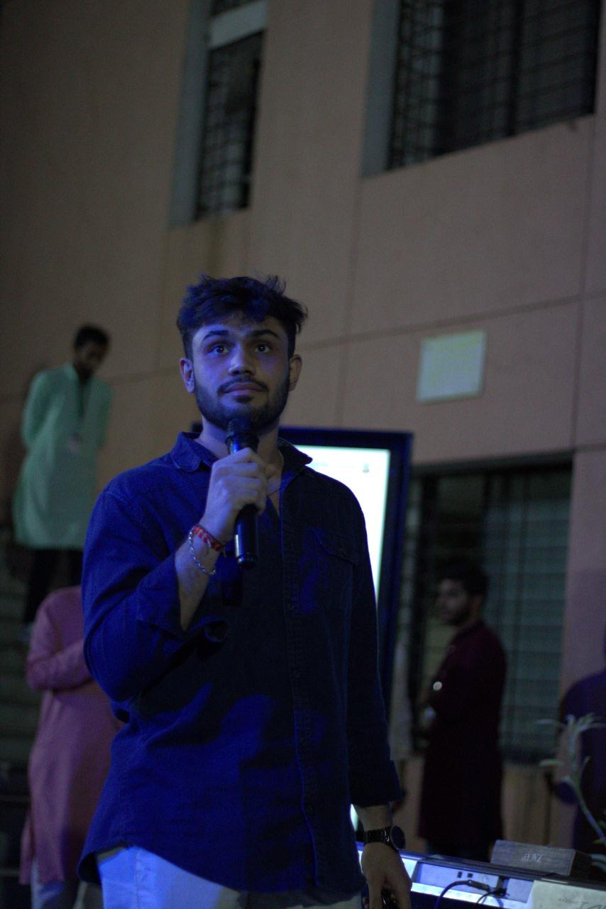 Devang on stage with mic